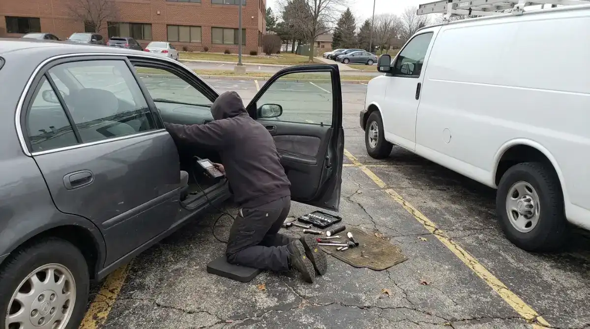 Mobile mechanic working under the hood of a car in a Columbia SC driveway