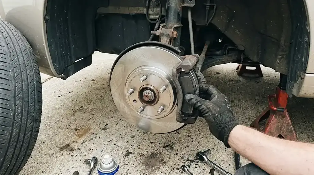 Mechanic replacing brake pads and rotor at a home in Columbia SC